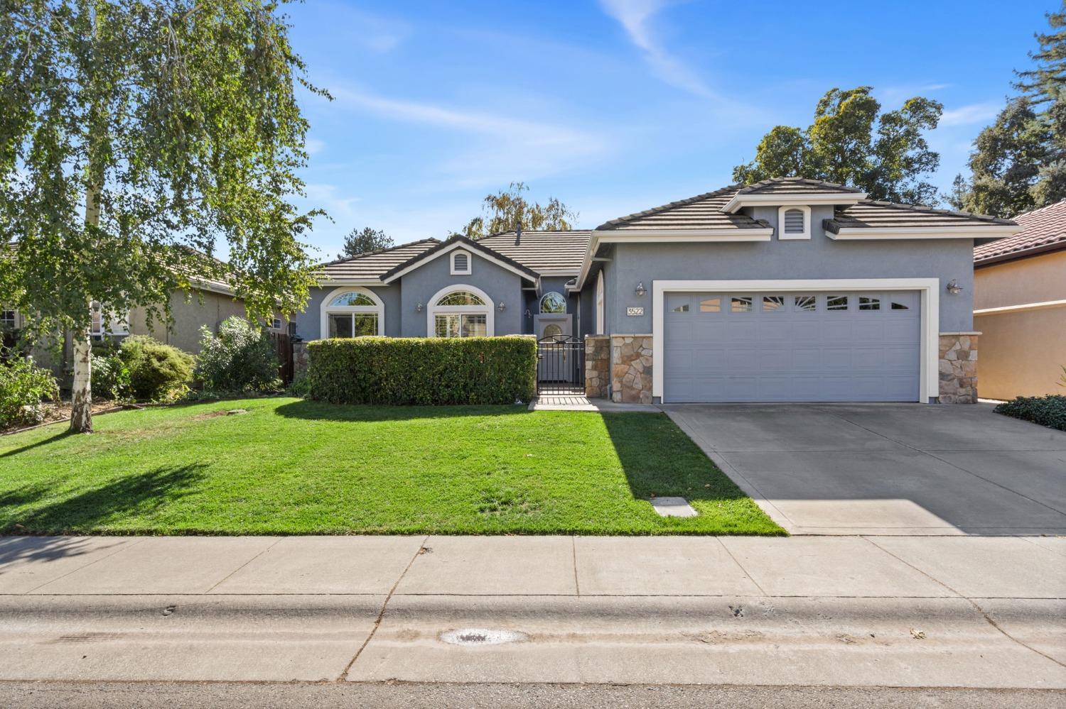 a front view of a house with a yard and garage