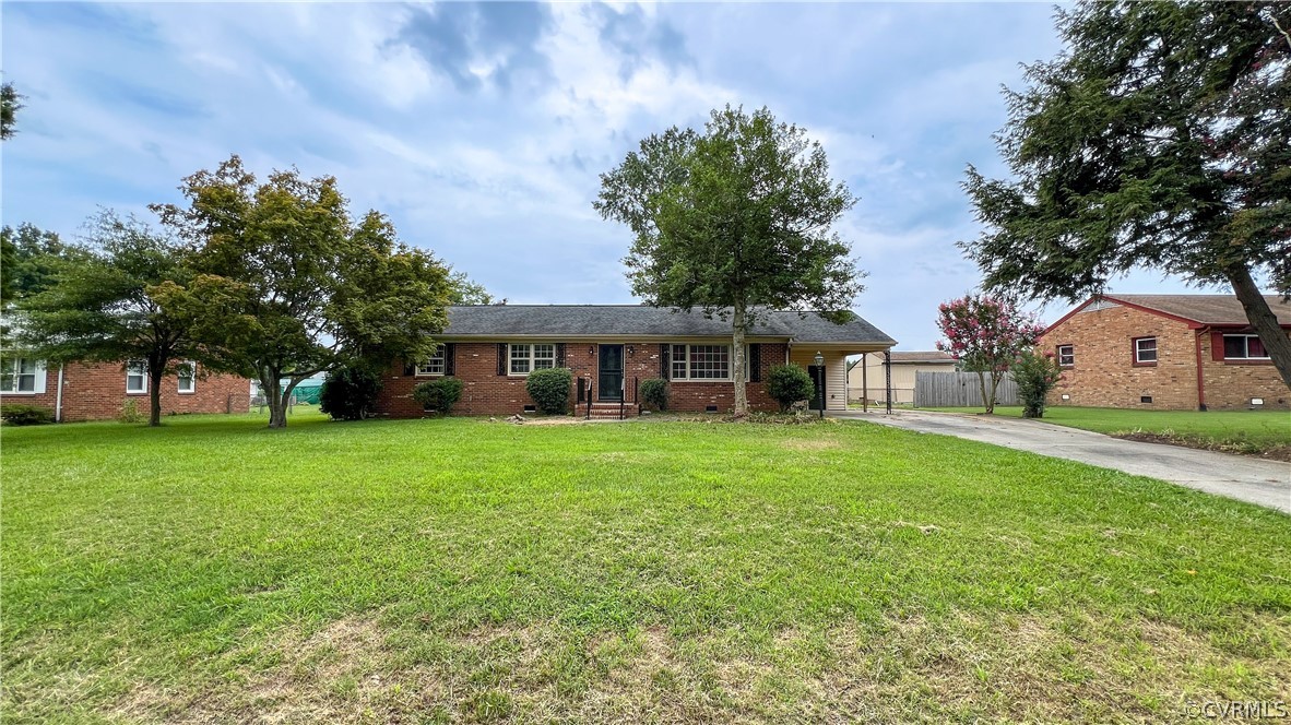 a front view of a house with a yard and trees