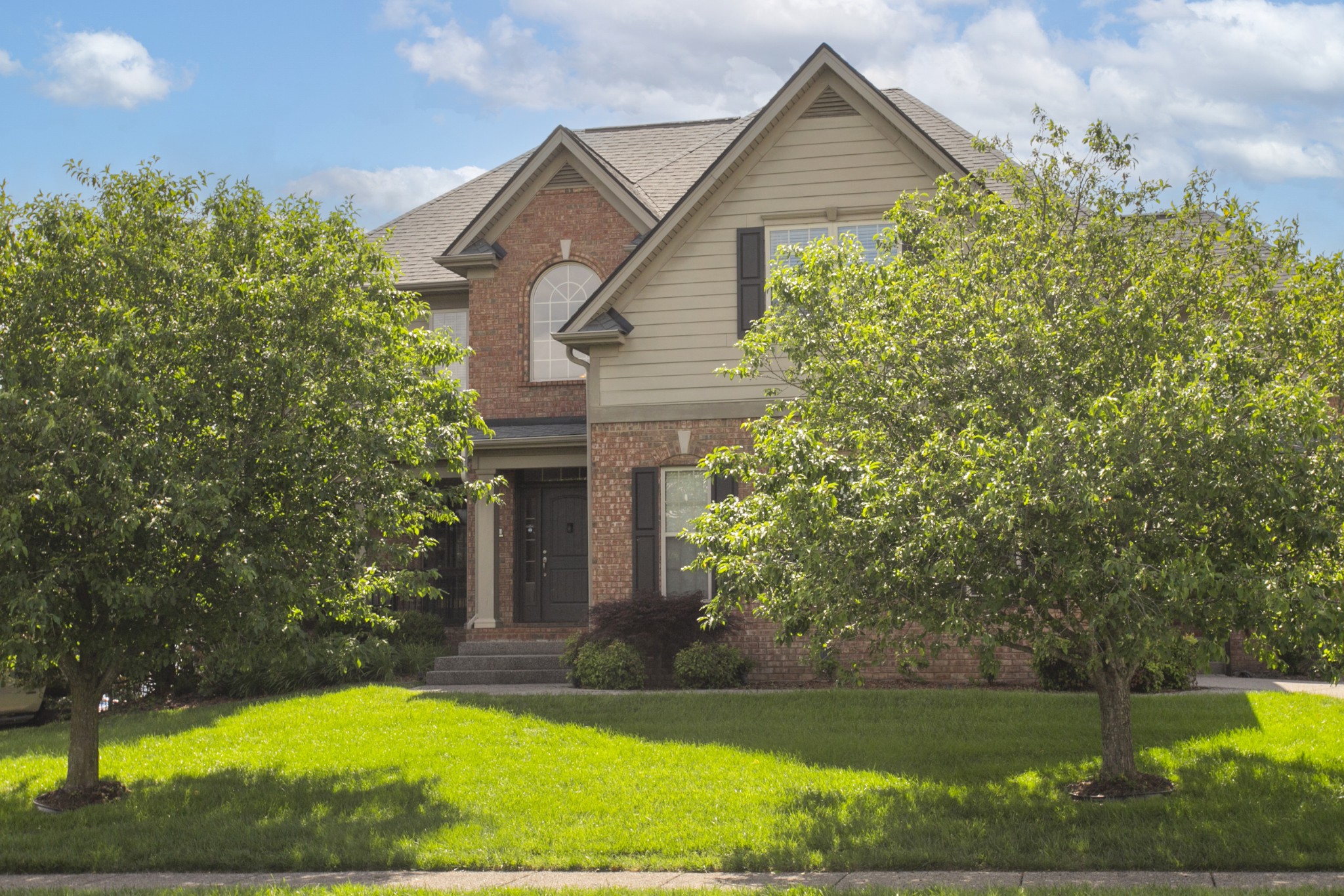 a view of a house with a yard and plants