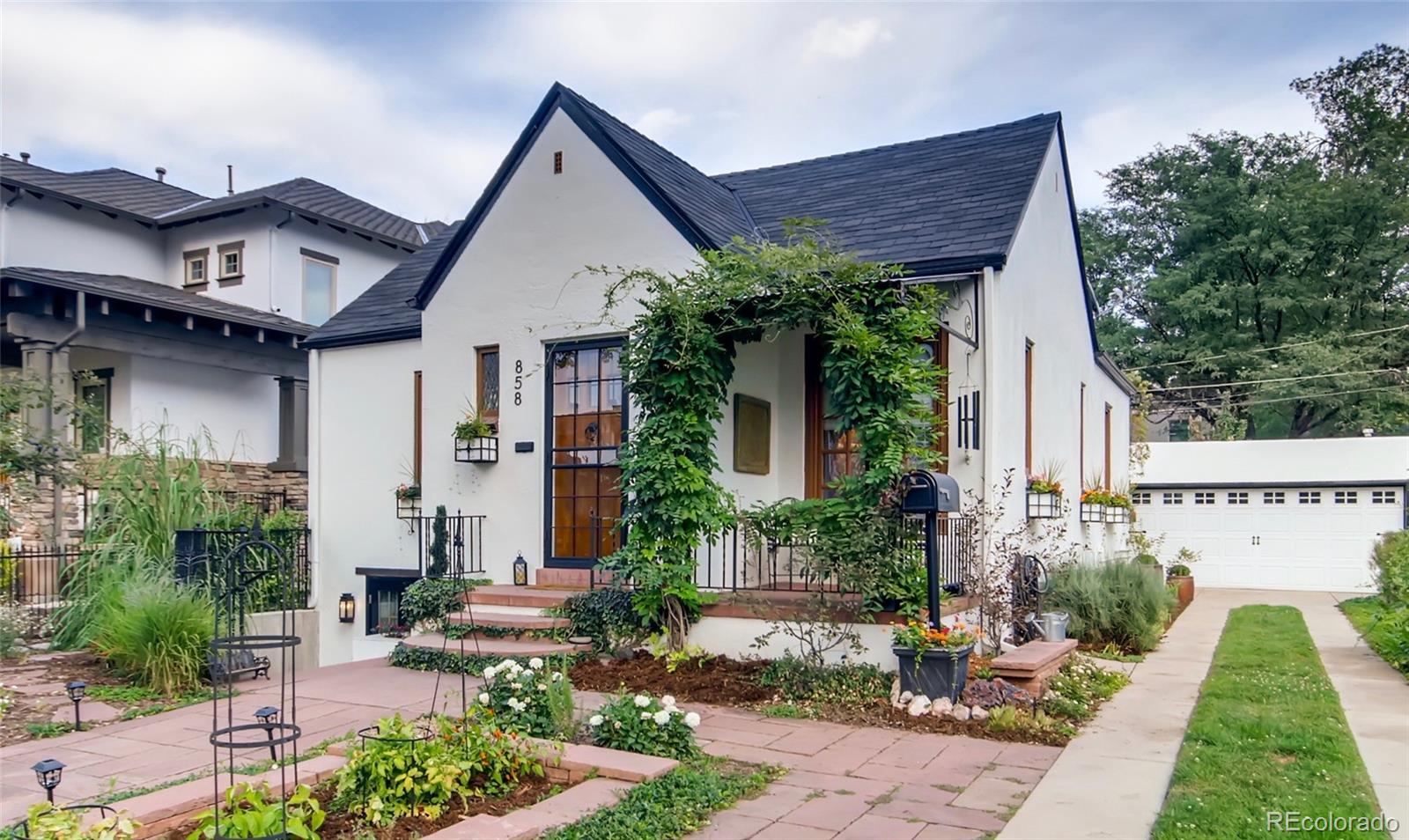 a front view of a house with garden