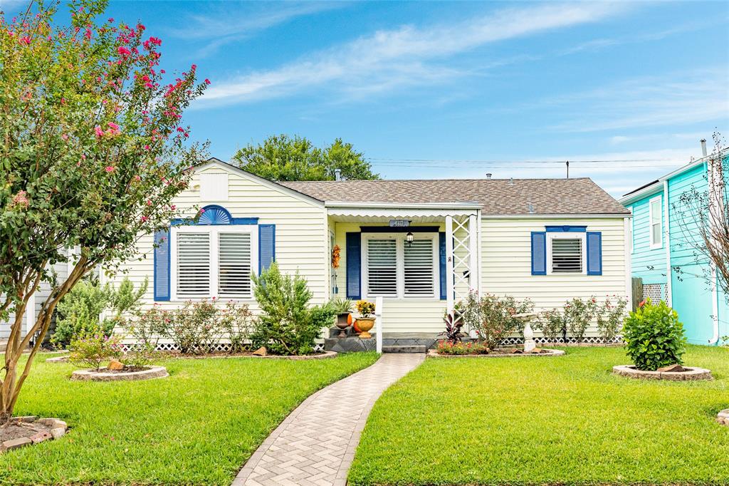 Landscaped front yard has established rose bushes and perennials