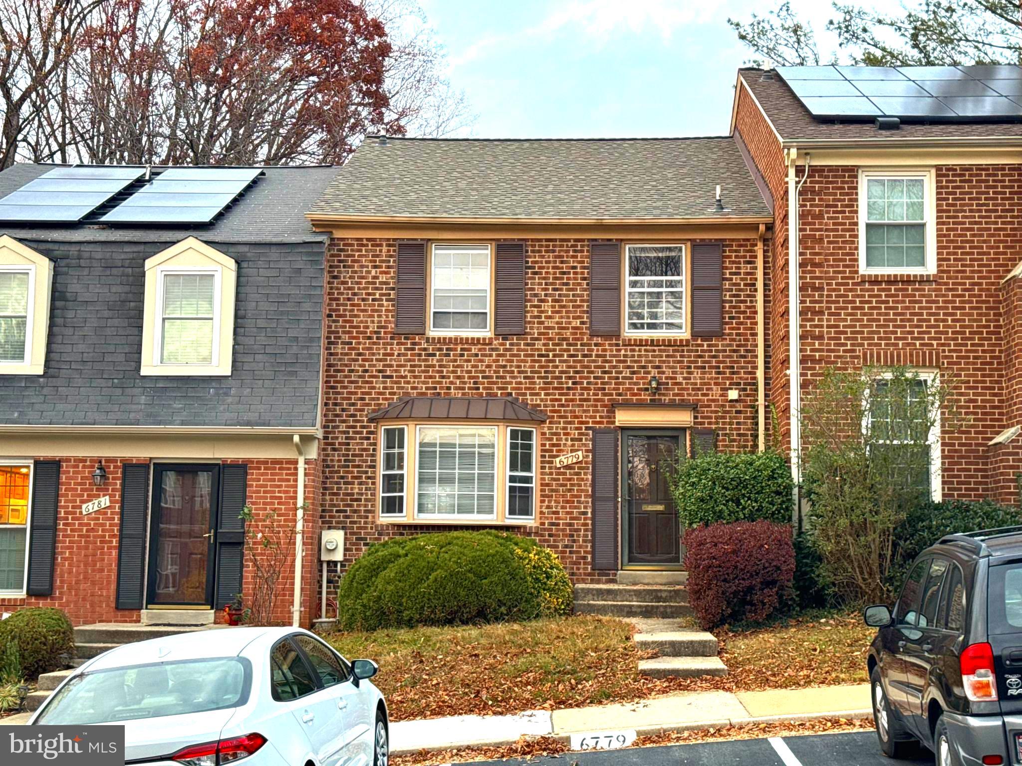 a front view of a house with a yard and outdoor seating