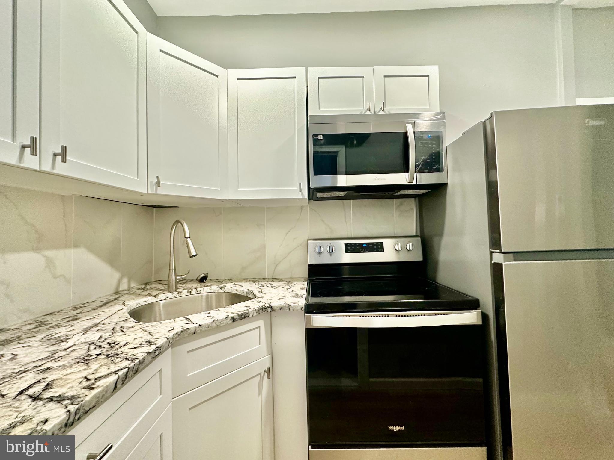 a kitchen with a sink and a stove