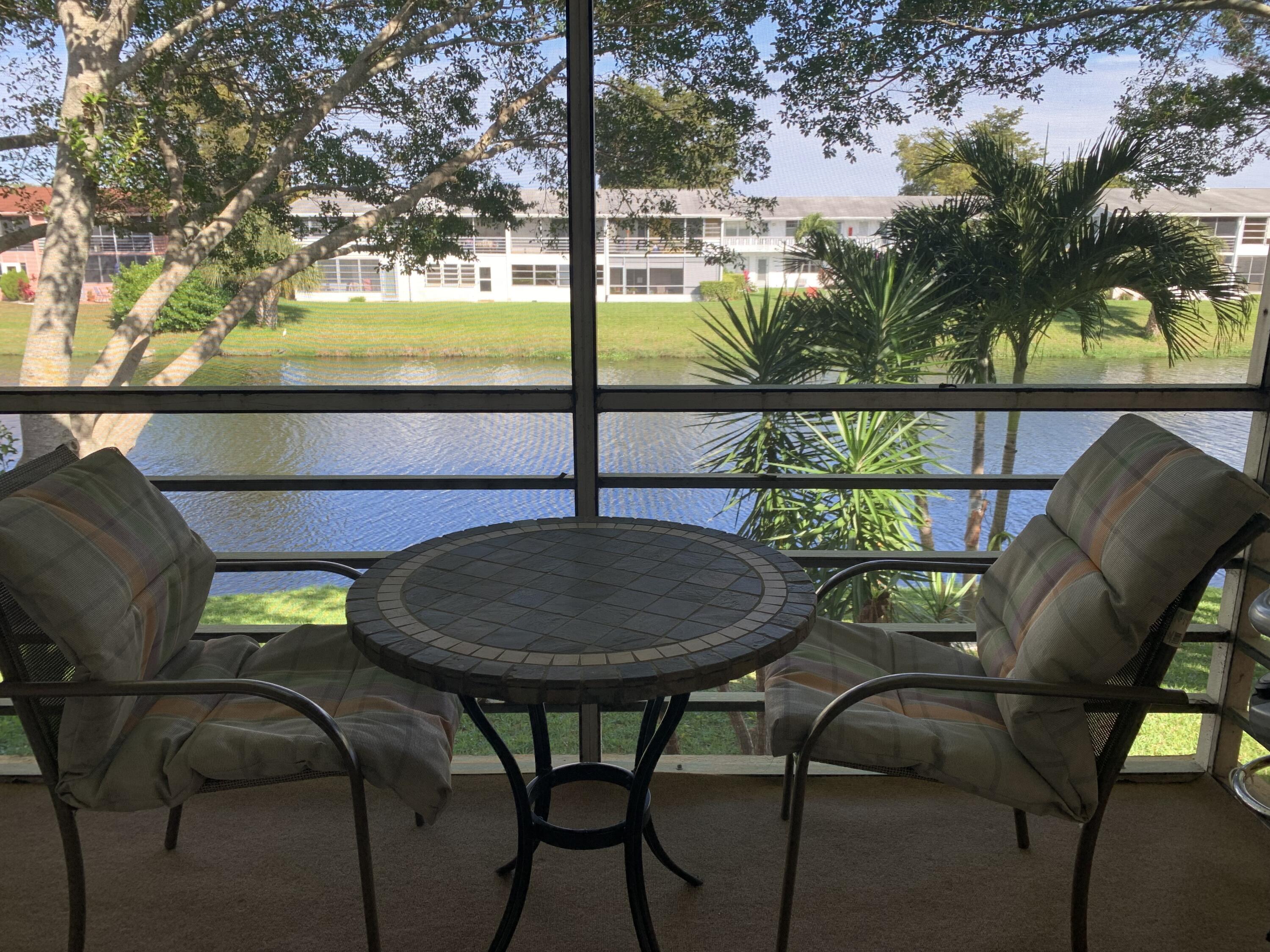 a view of a chairs and table in patio