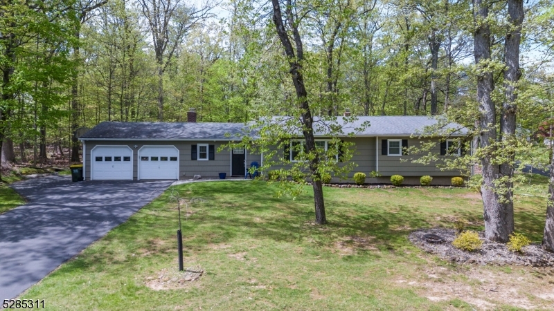 a view of a house with a yard tree and a deck