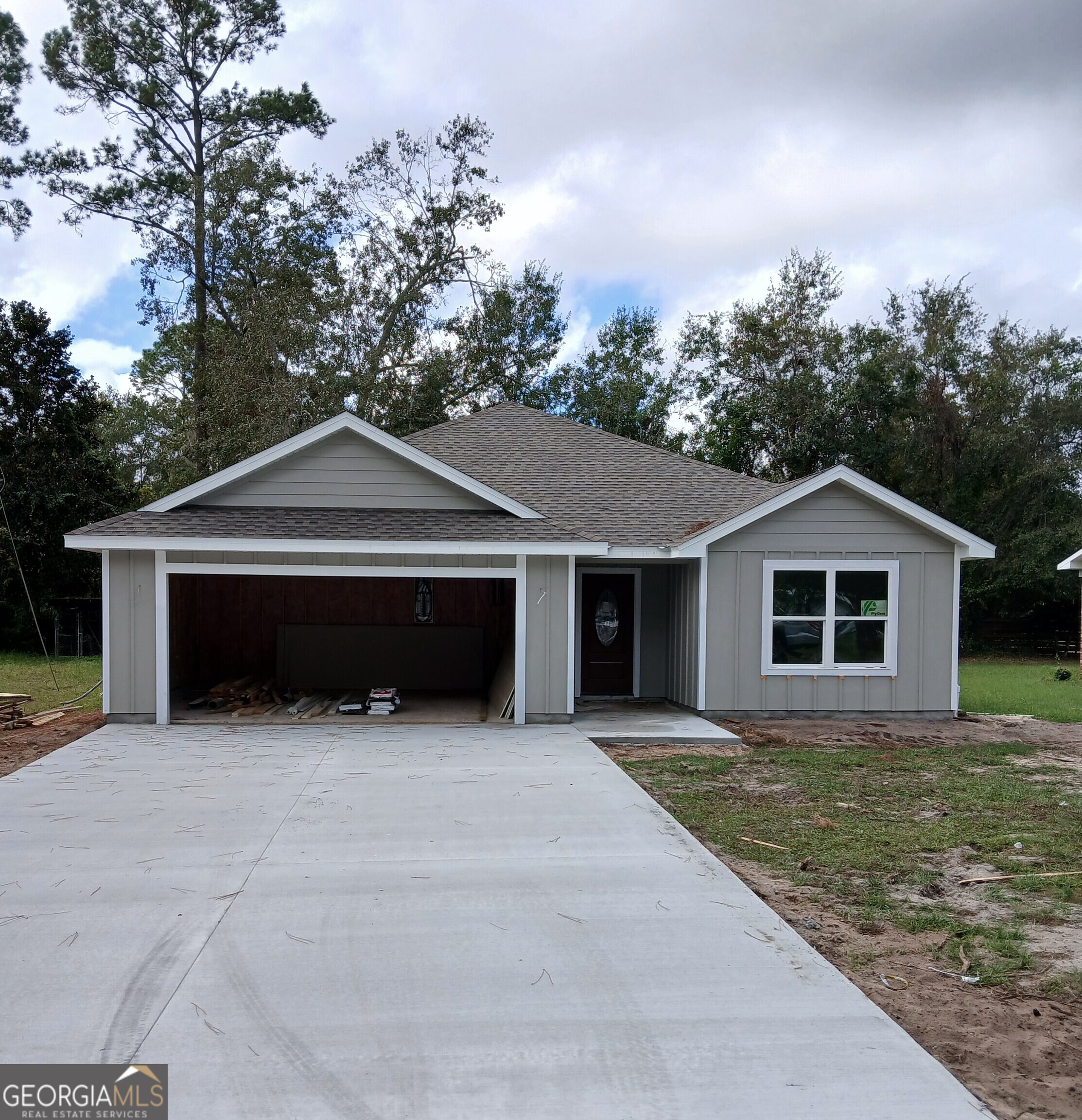 a front view of house with yard and trees