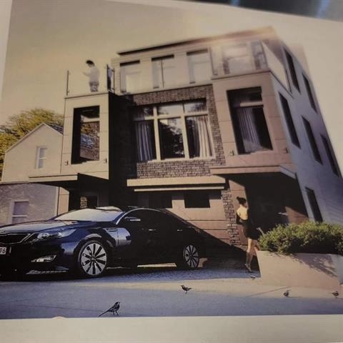 a view of a car parked in front of a building