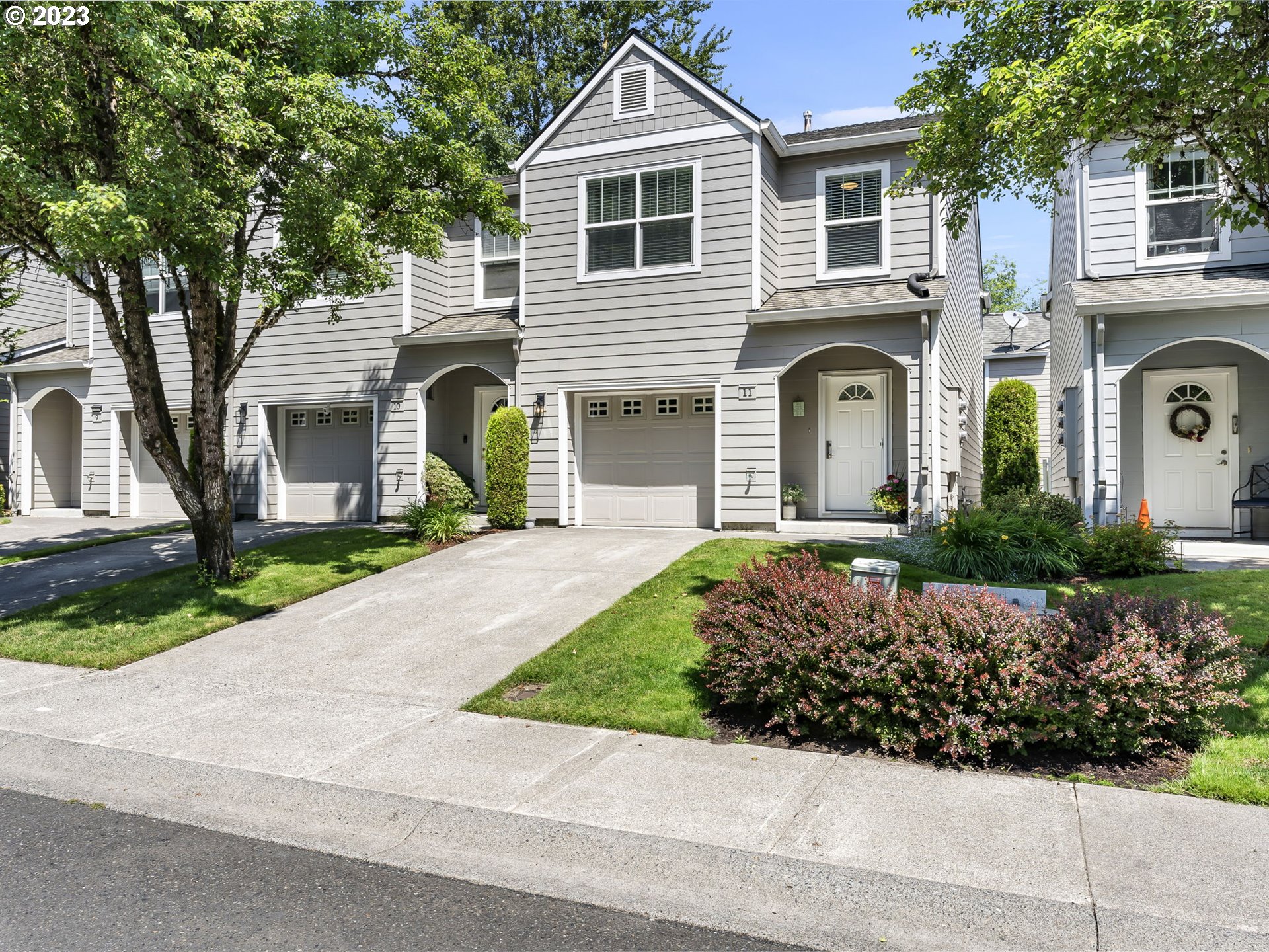 a front view of a house with a garden