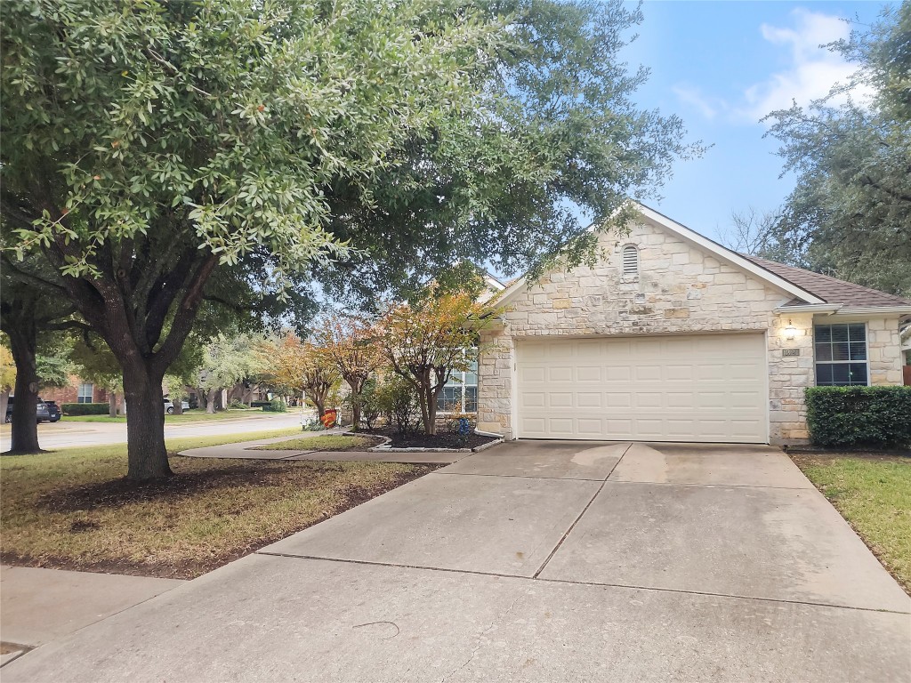 a front view of house with yard and trees