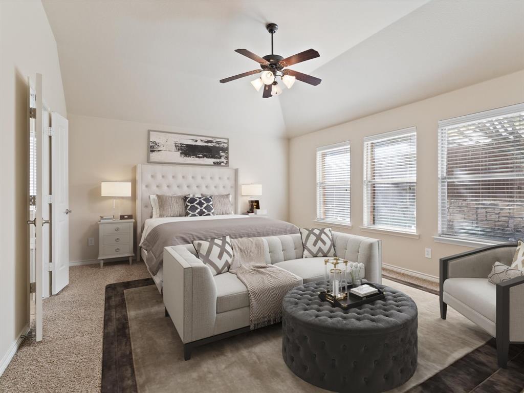 a bedroom with furniture and a large window