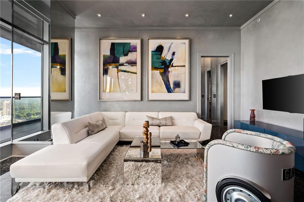 a living room with furniture and a flat screen tv