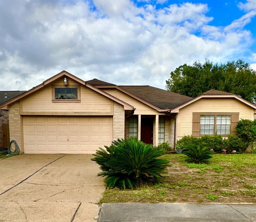 a front view of house with yard and trees around