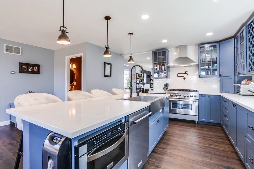 a large kitchen with stainless steel appliances lots of counter space