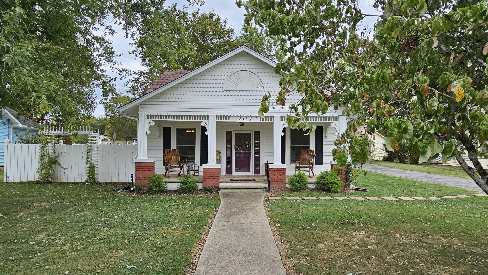 a front view of house with yard and green space