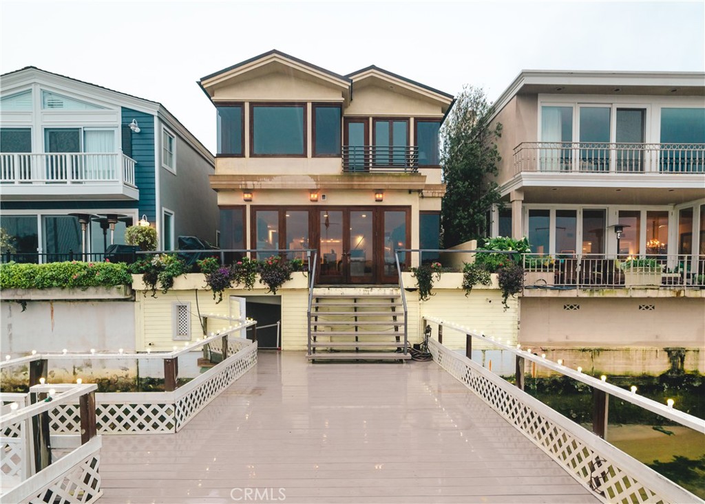 a front view of a house with swimming pool and sitting area