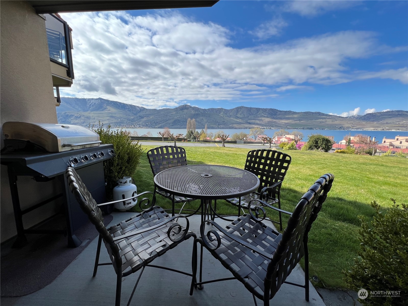 a backyard of a house with table and chairs