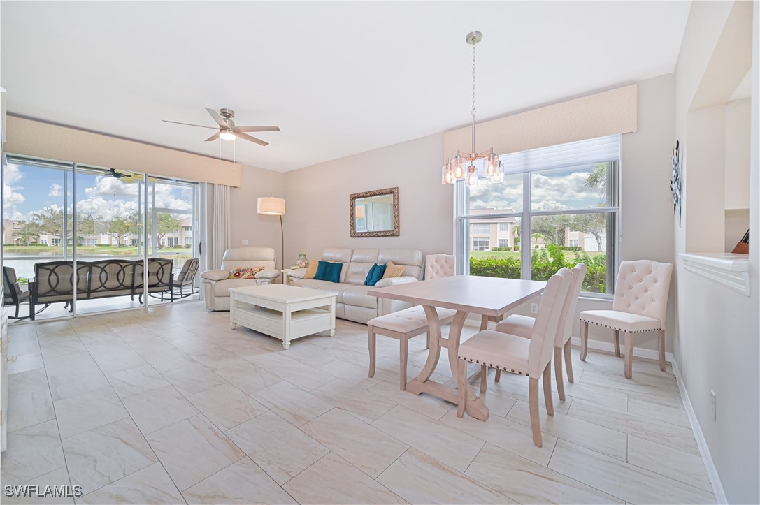 a living room with patio furniture and a large window