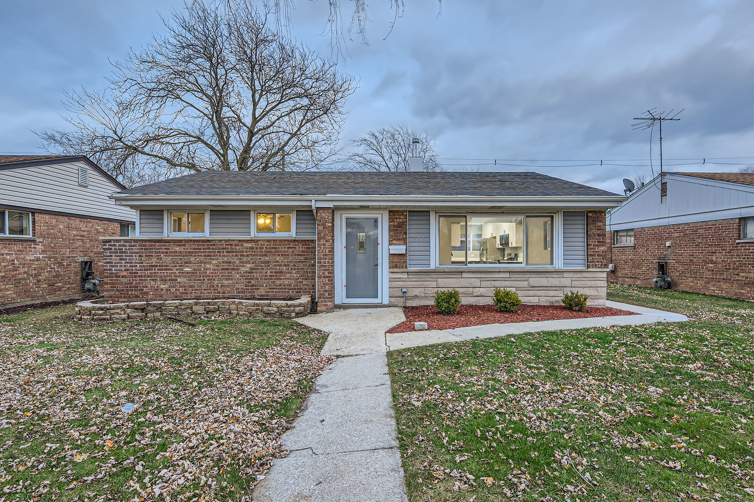 a front view of a house with garden and patio