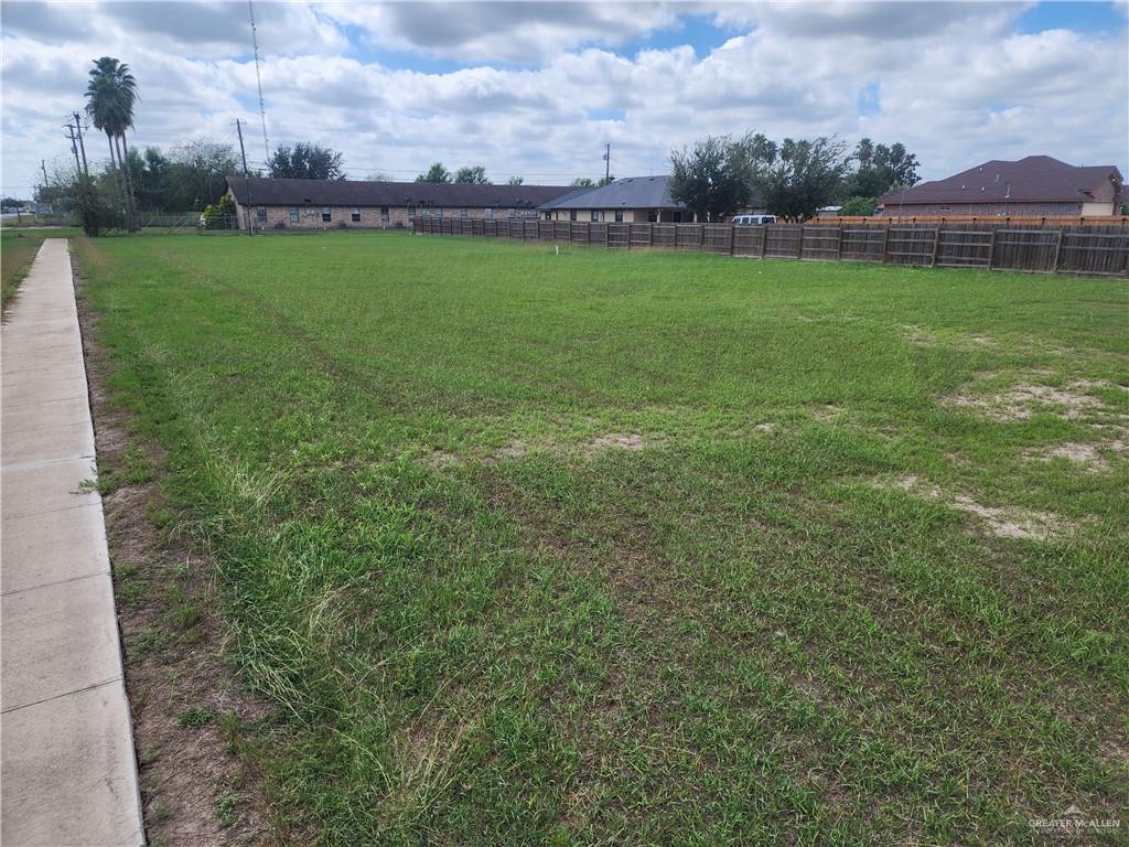 a view of a field of grass and trees