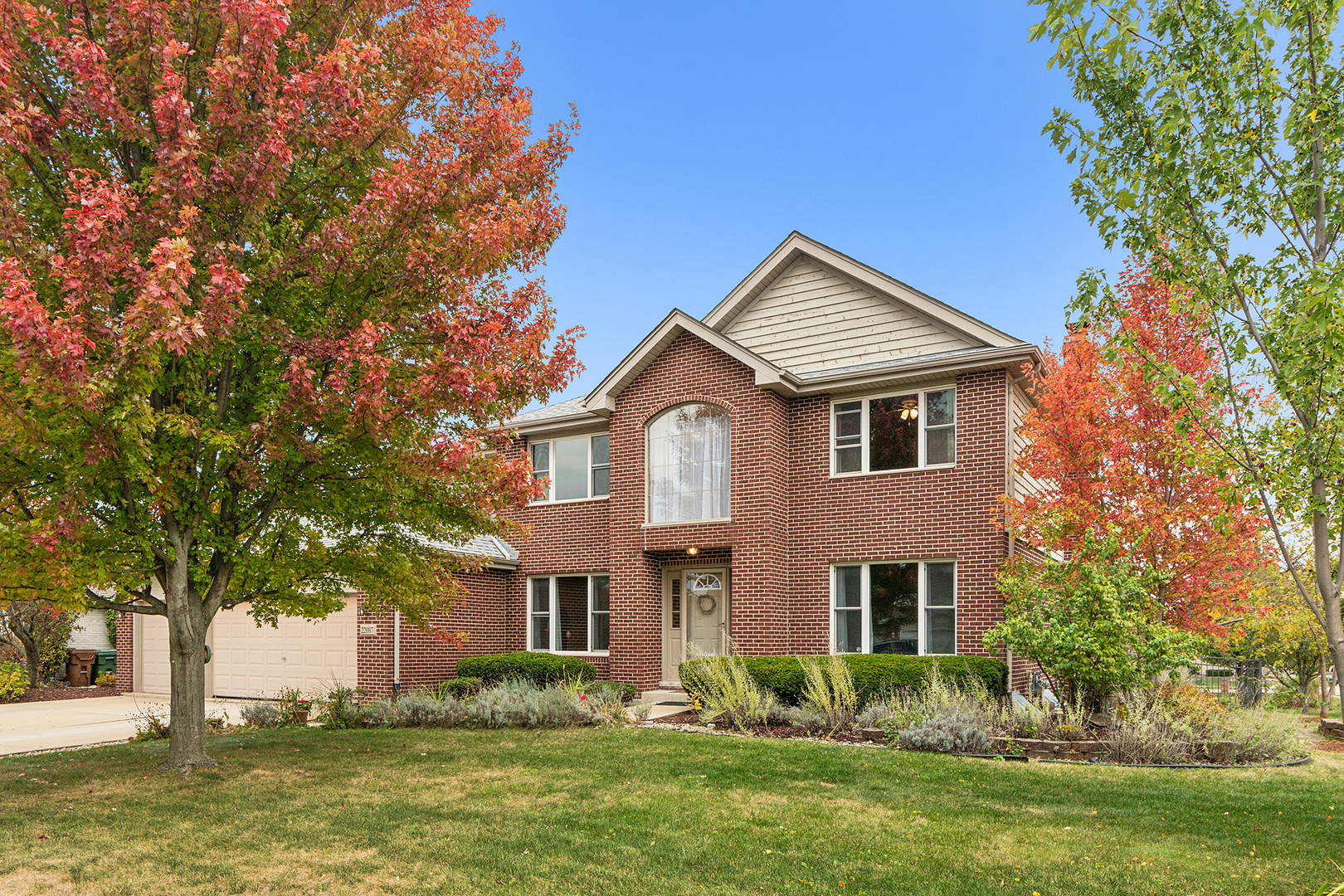 a front view of a house with a yard