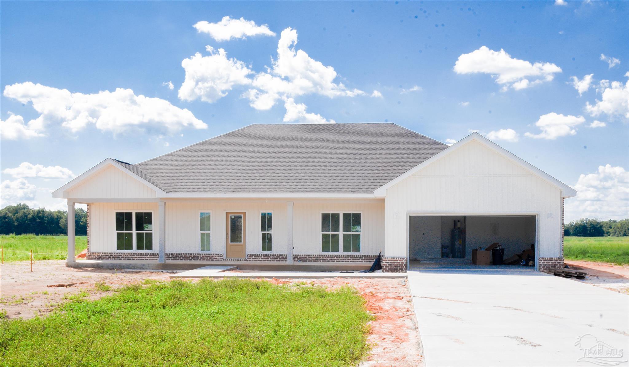 a view of a house with backyard and sitting area