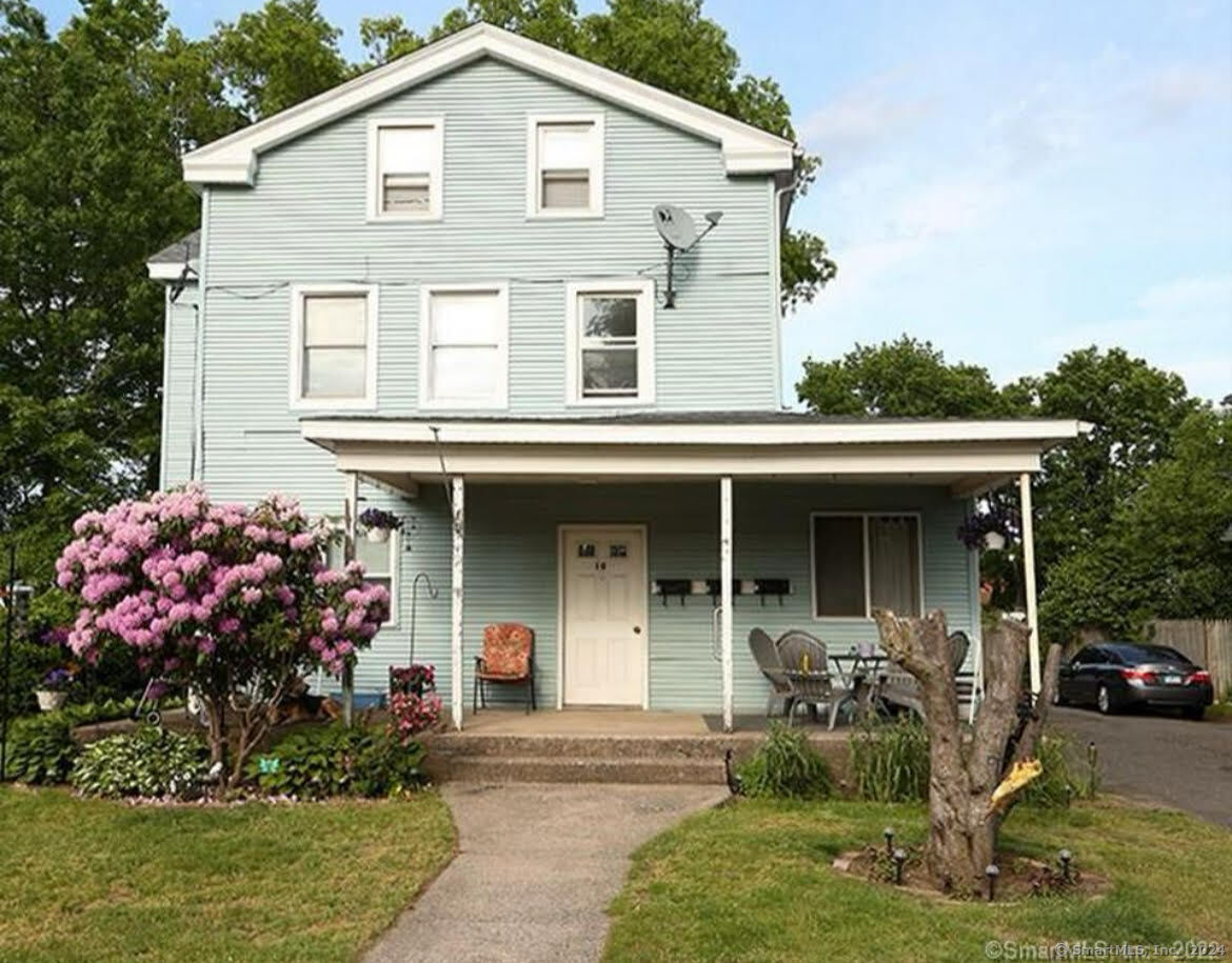 a front view of house with yard outdoor seating and garage