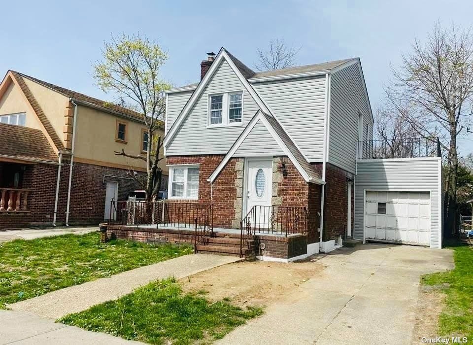 a view of a house with a yard and garage