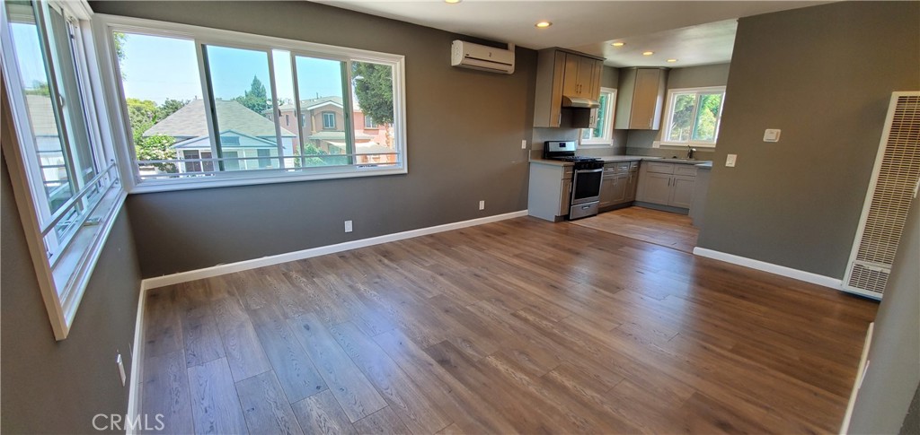 a view of kitchen with cabinets and wooden floor