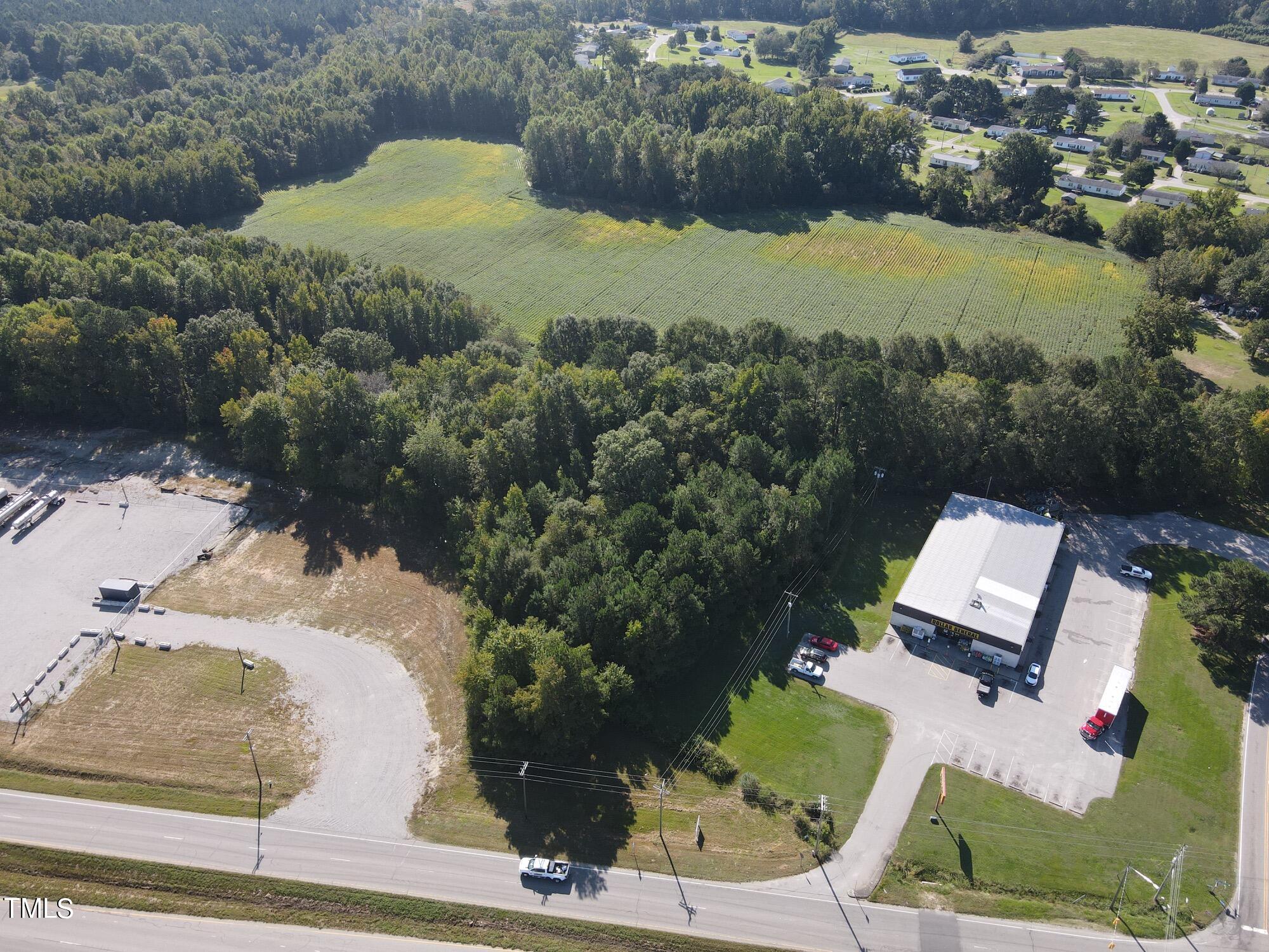 an aerial view of a house with garden space and street view