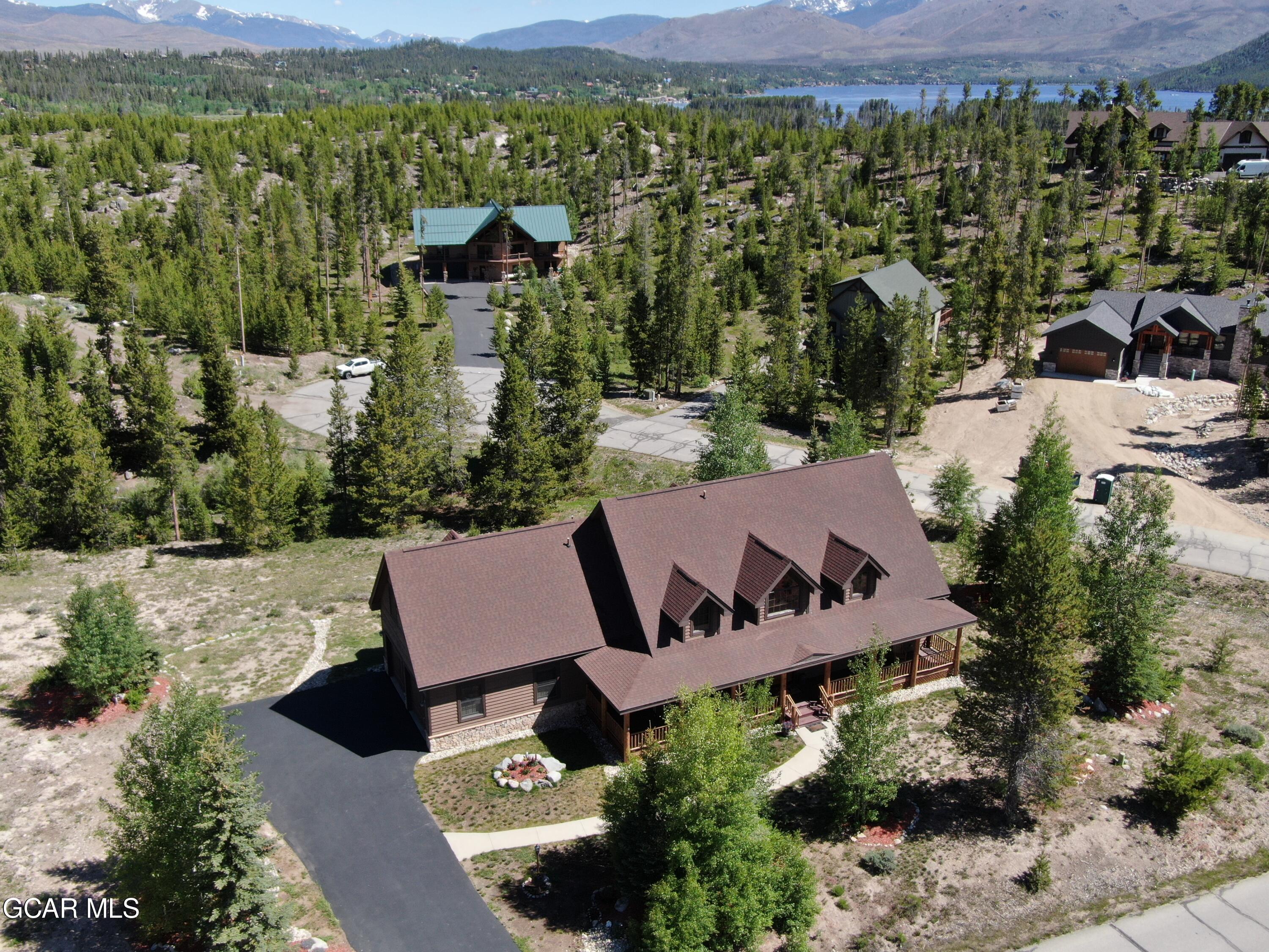 an aerial view of a house with a yard