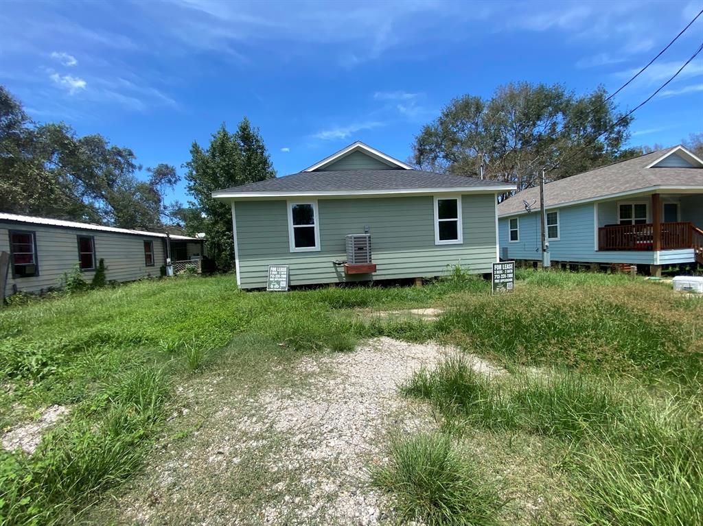 a view of a house with yard and a garden