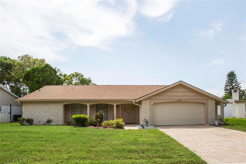 a front view of house with yard and green space