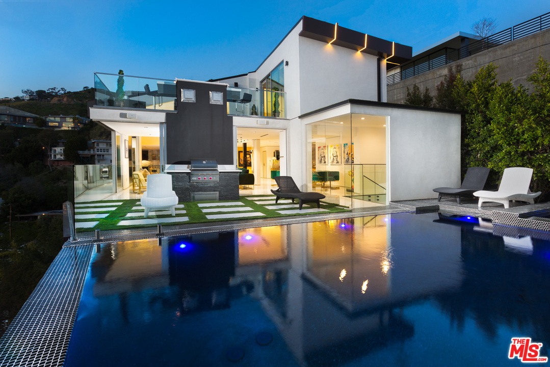 a swimming pool view with a outdoor seating