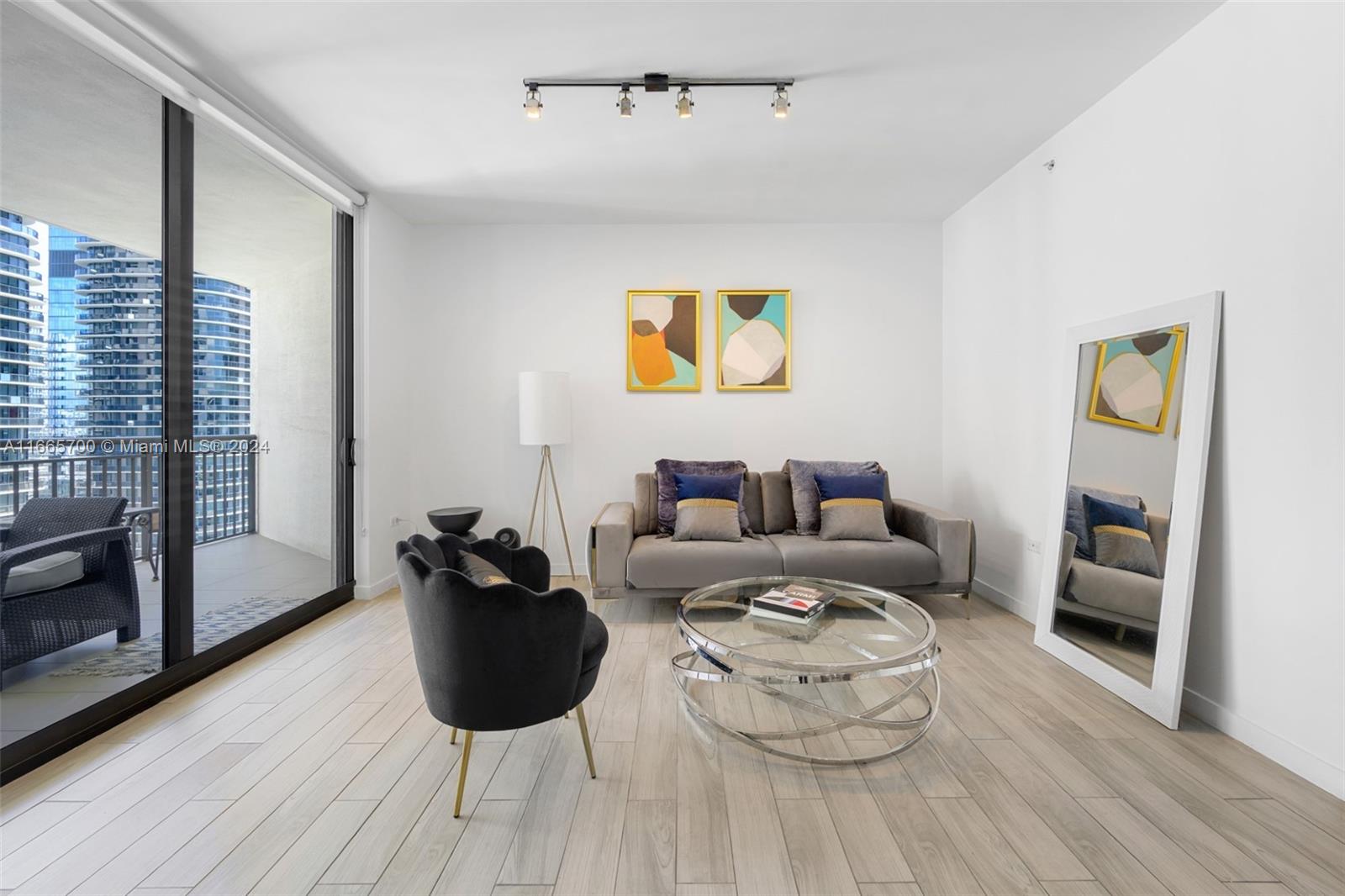 a living room with furniture fireplace and wooden floor