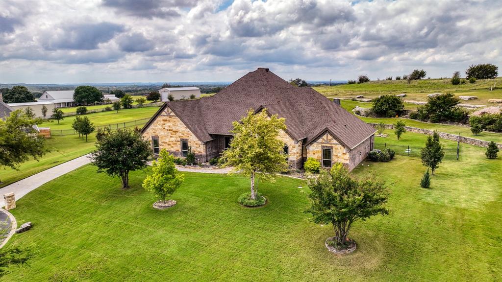 an aerial view of a house with swimming pool and sitting space