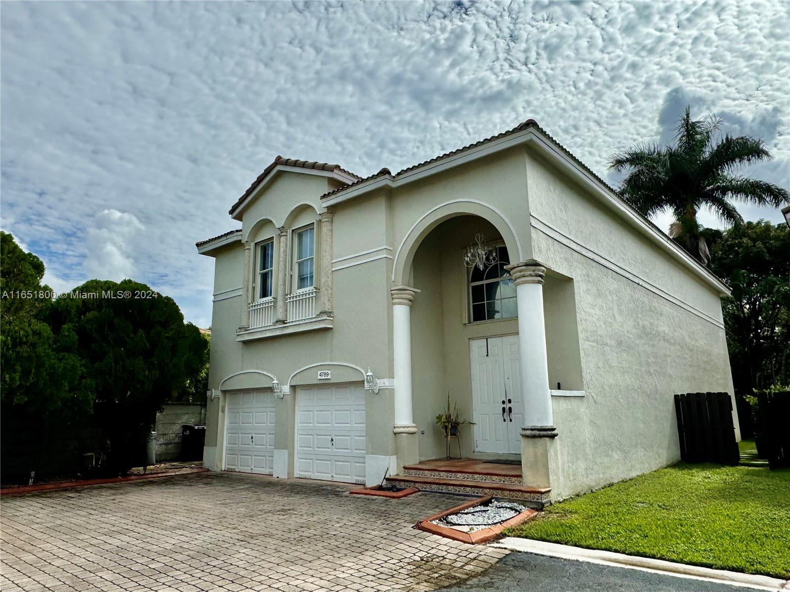 a front view of a house with garden