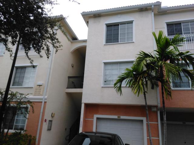 front view of a house with a potted plant and a potted plant