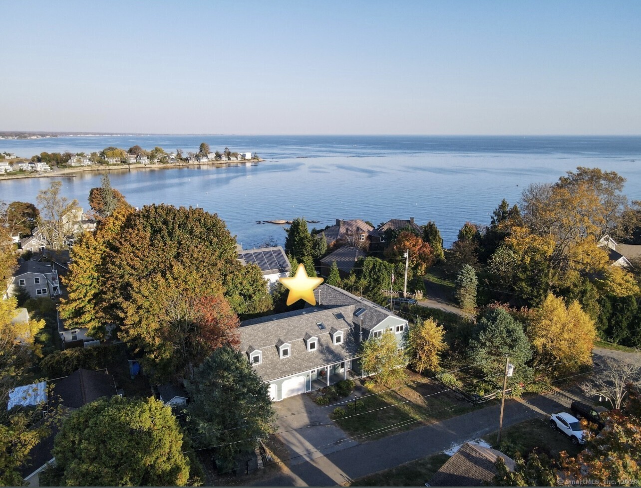 Aerial photo showing the house and surrounding property, as well as proximity to the beach.