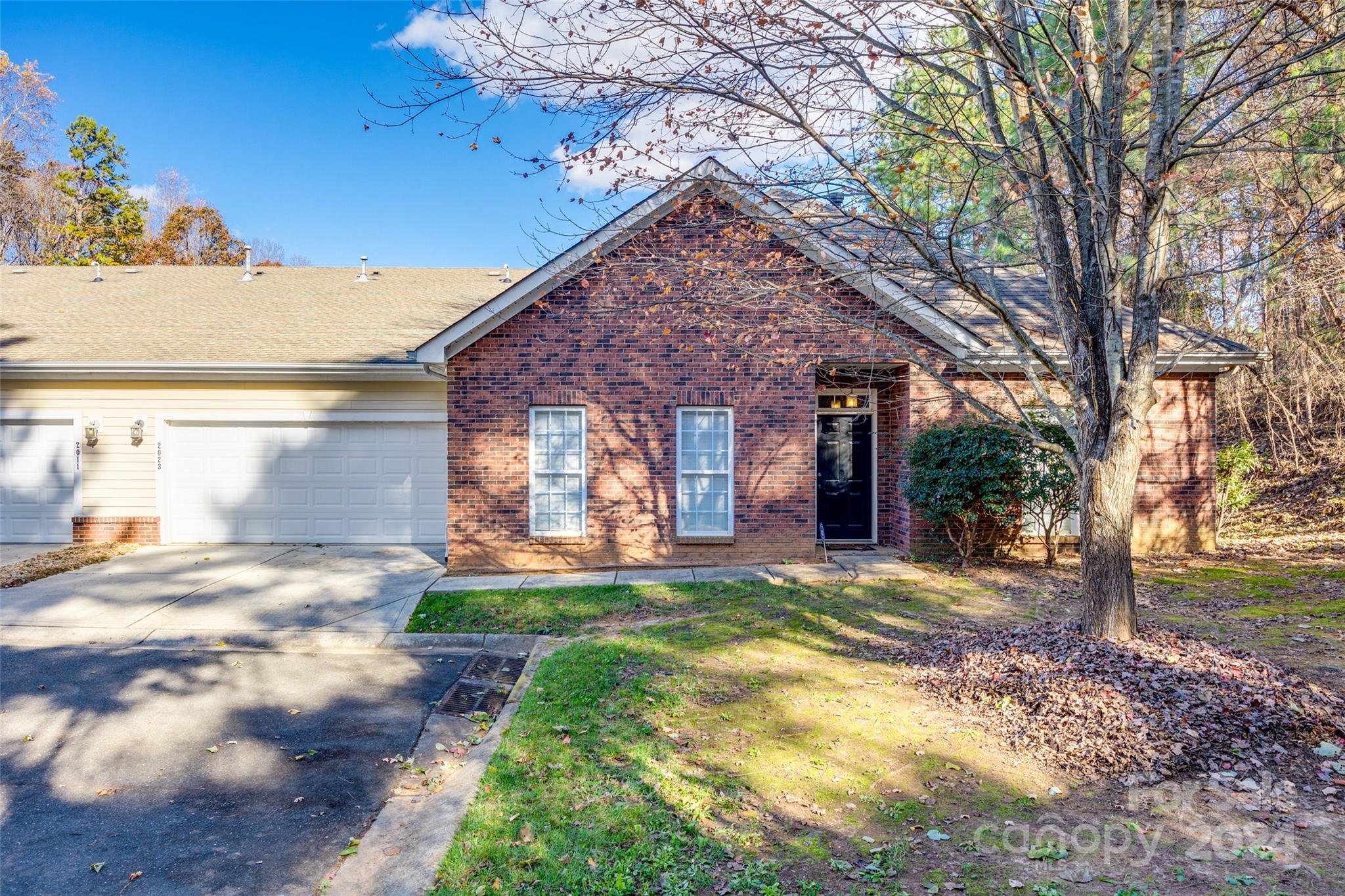 a view of a house with a yard and tree s