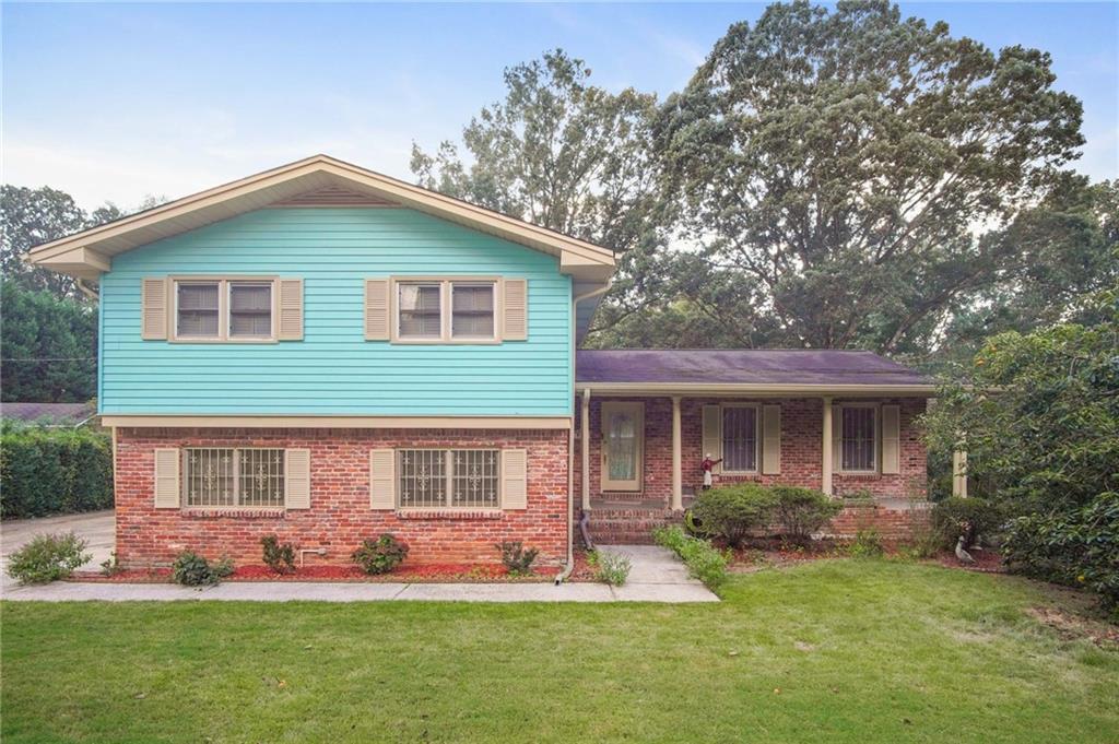 a front view of house with yard and green space