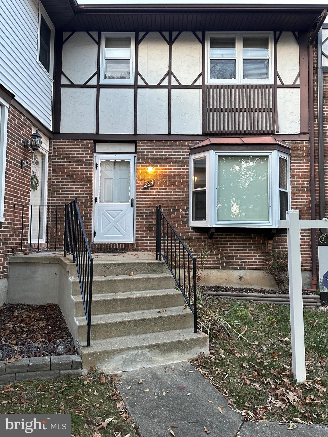 a view of a brick house with a large window