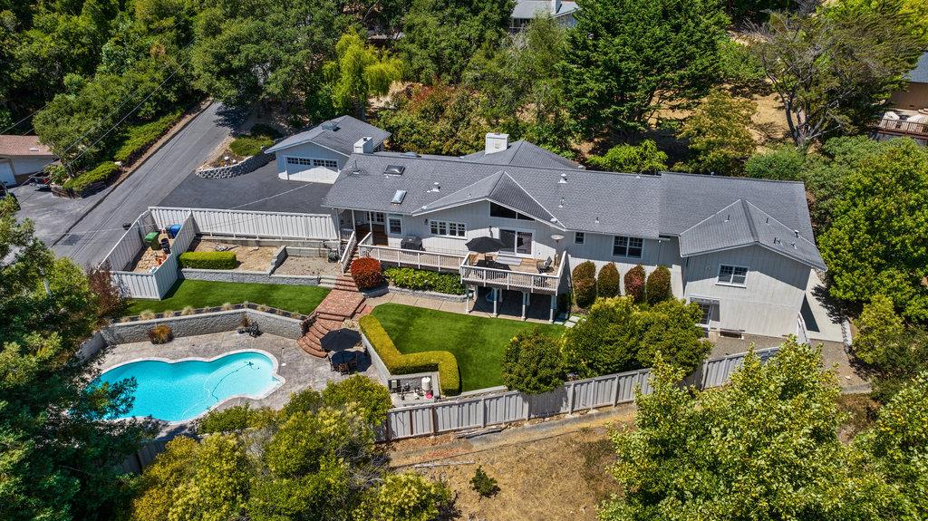 an aerial view of a house with garden space and street view