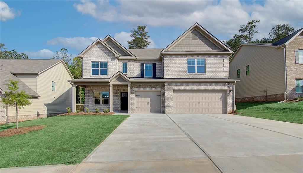 a front view of a house with a yard