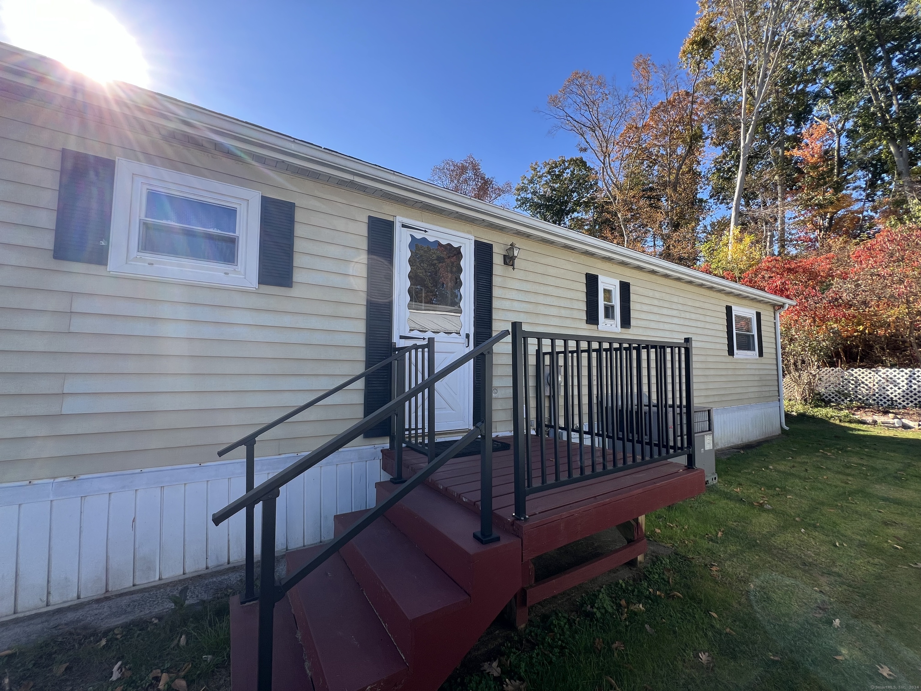 a view of a house with a yard and deck