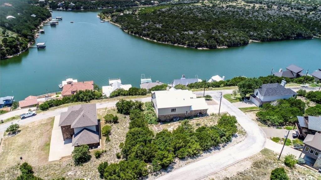 an aerial view of a house with outdoor space and lake view