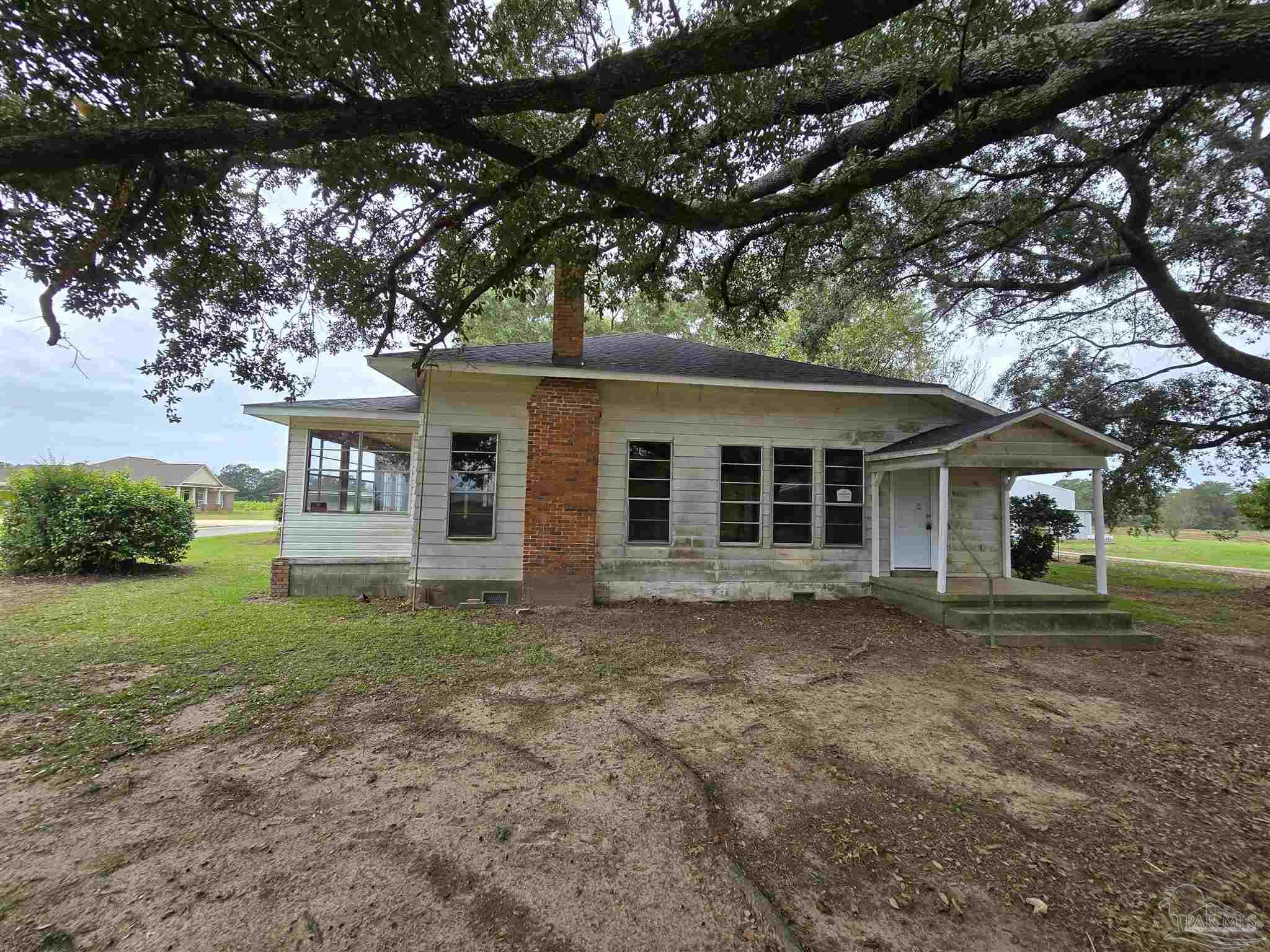 a front view of a house with a garden