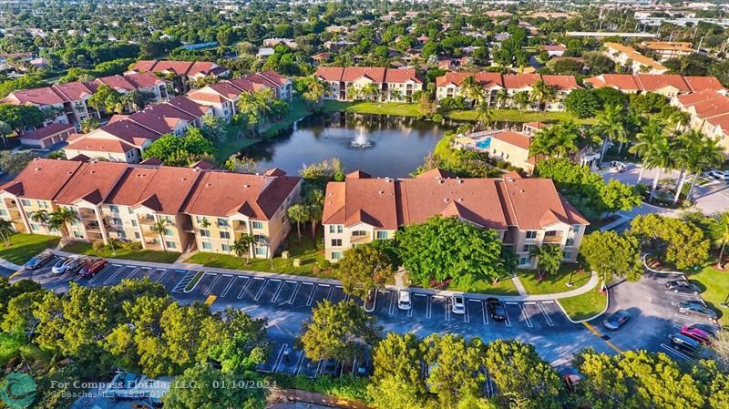 an aerial view of residential houses with outdoor space and swimming pool