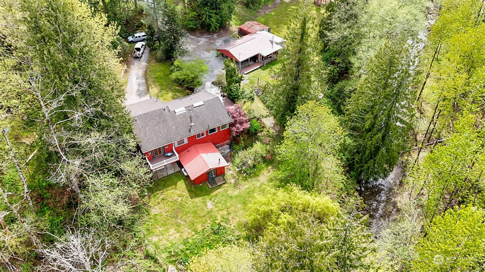 an aerial view of a house with a yard and swimming pool