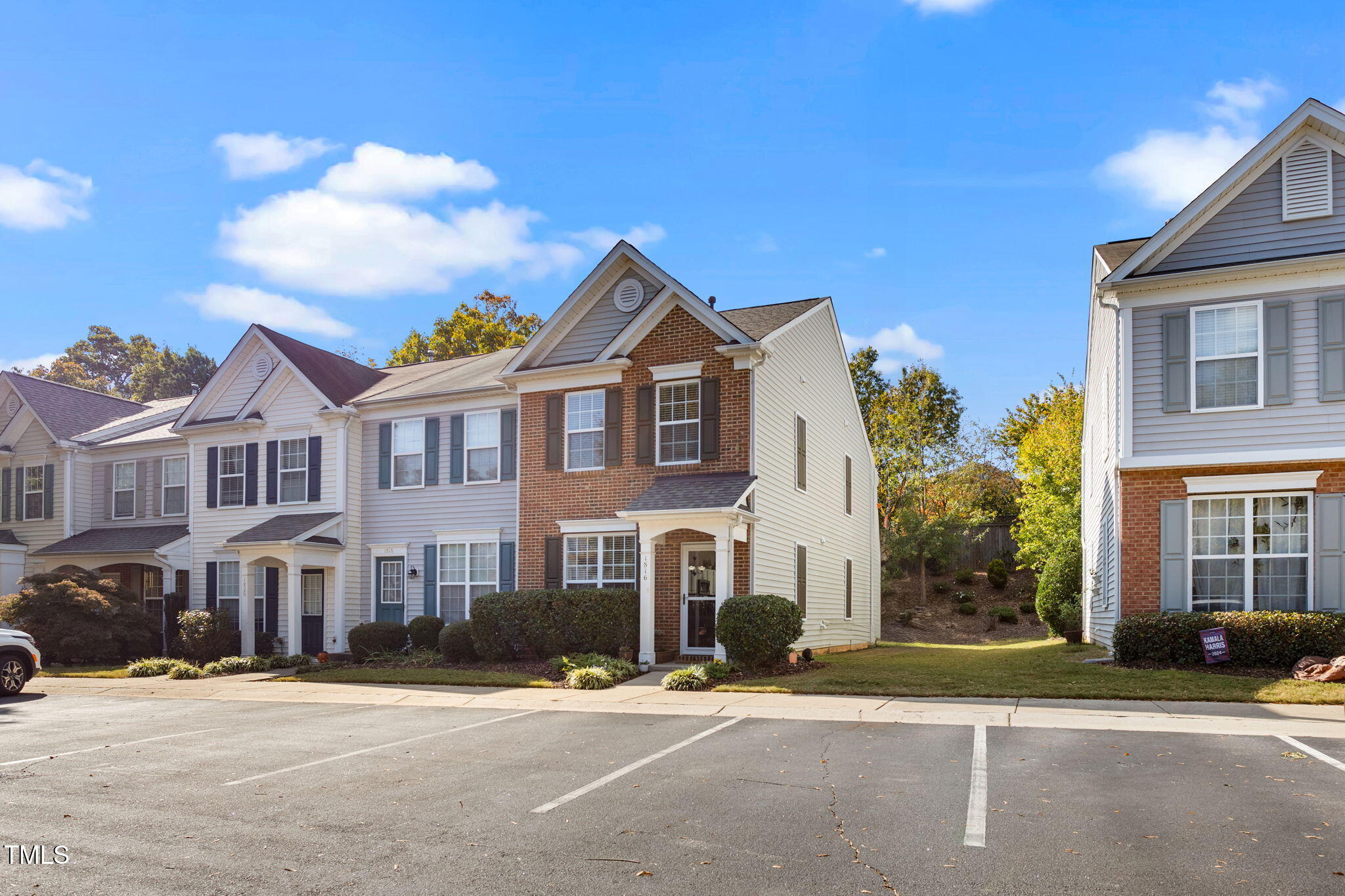 a front view of a residential houses with yard