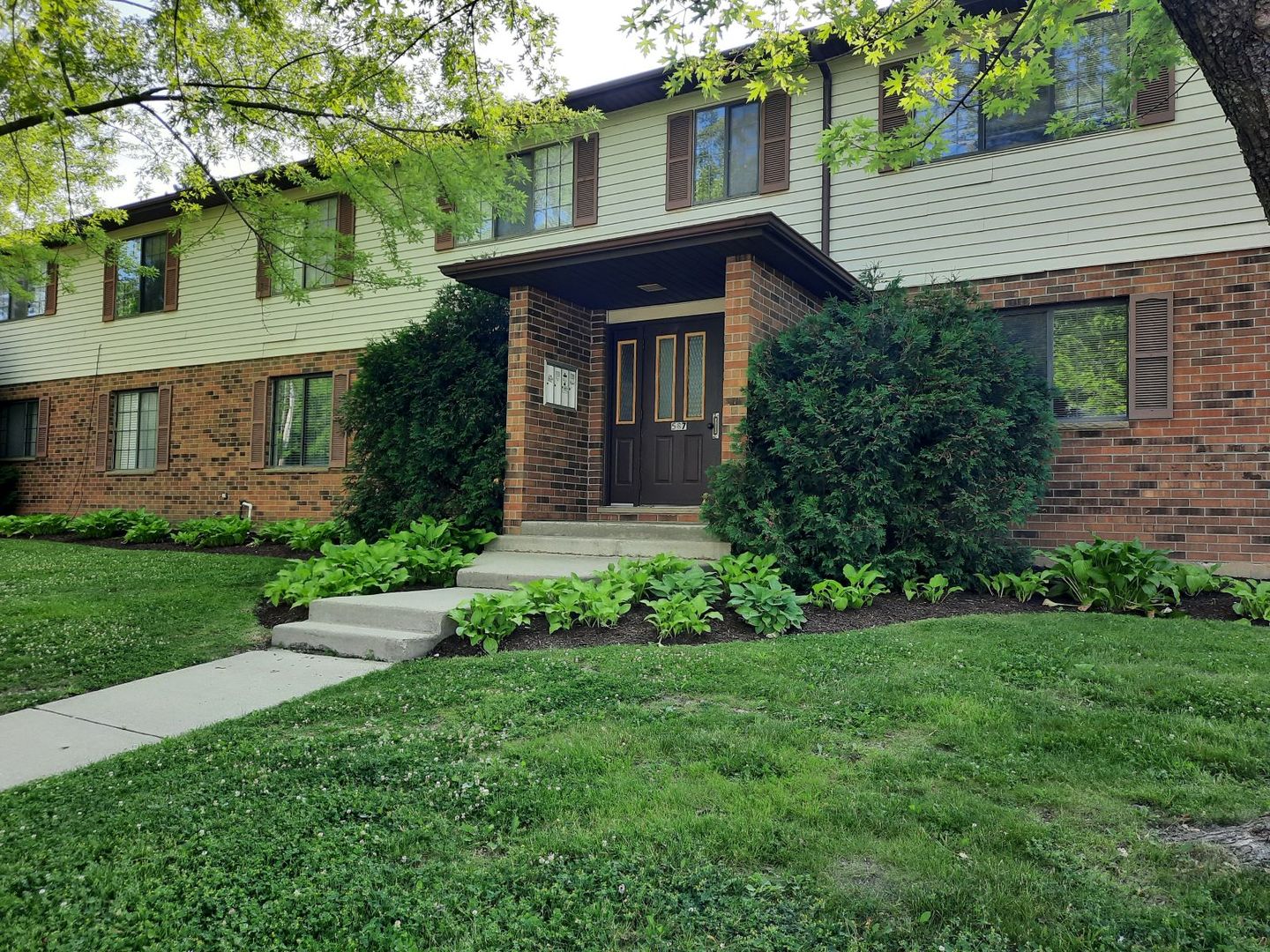 a front view of a house with a garden